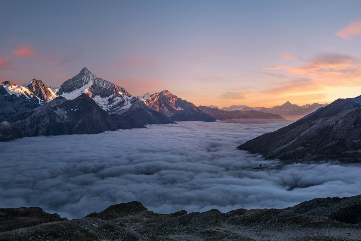 Soft light over distant mountain peaks above a quiet valley